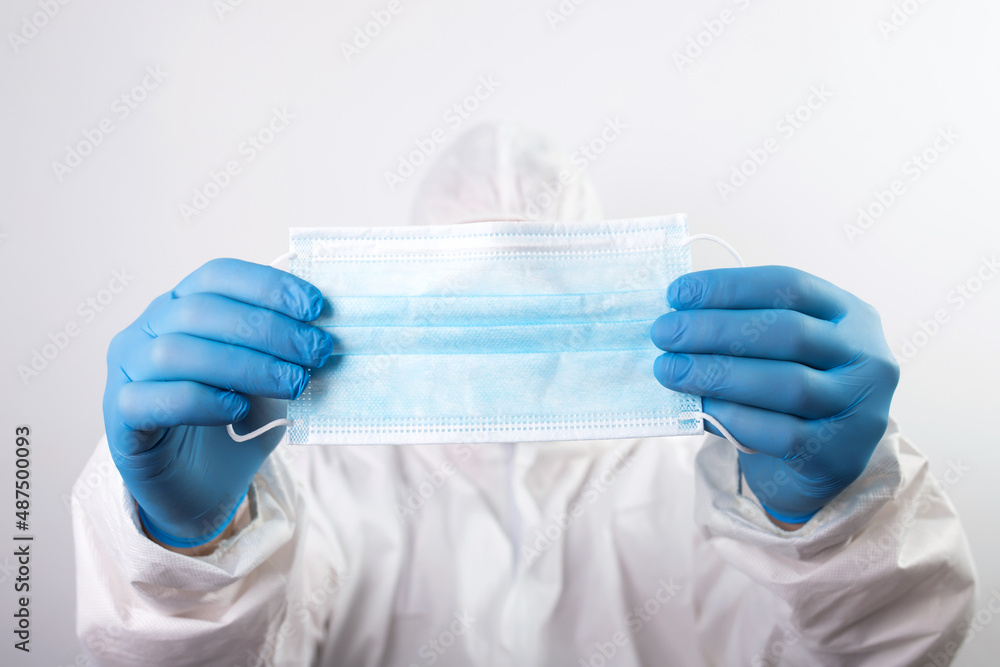 Fototapeta premium Close up of doctor hand holding surgical face mask