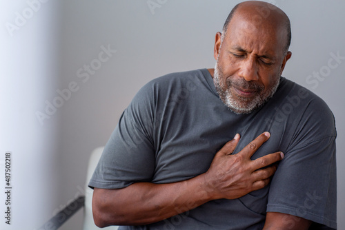 Portrait of an older senior man having chest pain.
