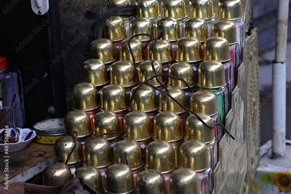 Decorative display of paint cans made of gold in the shoe shine chest