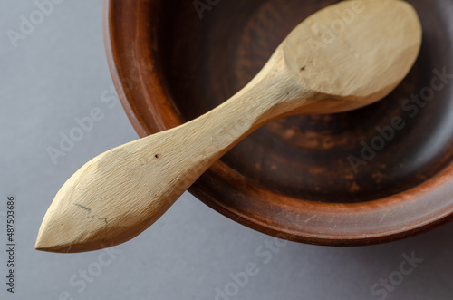 Canvas Print Brown earthenware bowl and buckshot against a gray background.