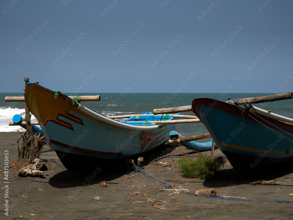 OLYMPUS DIGITALTwo fishing boats are docked on the beach of Goa Cemara, south of the city of Yogyakarta, Indonesia, one afternoon on 18 May 2017. CAMERA OLYMPUS DIGITALTwo fishing boats are docked on the beach of Goa Cemara, south of the city of Yogyakarta, Indonesia, one afternoon on 18 May 2017. CAMERA