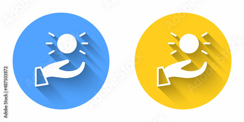 White Ball levitating above hand icon isolated with long shadow background. Levitation symbol. Circle button. Vector