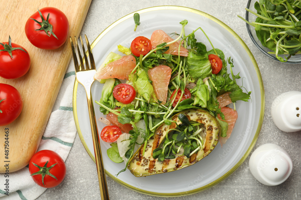Delicious pomelo salad with grilled avocado served on light grey table, flat lay Delicious pomelo salad with grilled avocado served on light grey table, flat lay
