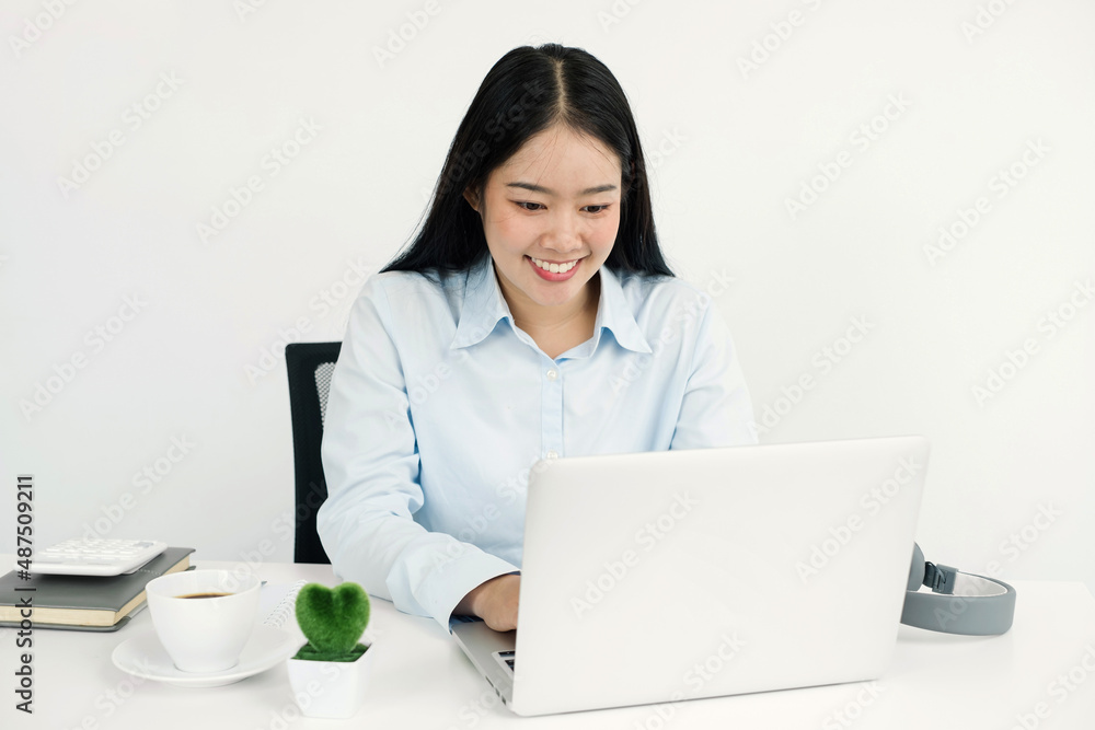 Asian woman working laptop. Successful smiling businesswoman sitting working at the office Asian woman working laptop. Successful smiling businesswoman sitting working at the office