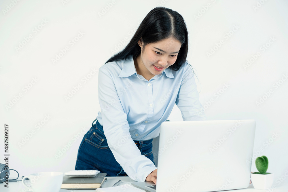 Asian woman working laptop. Successful smiling happy businesswoman working at the office Asian woman working laptop. Successful smiling happy businesswoman working at the office