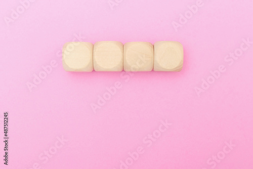 blank wooden block cubes on pink background. wood square toy learning joy idea.