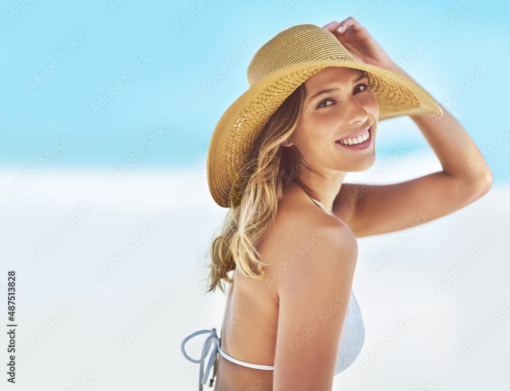 What a beautiful day at the beach. Portrait of a gorgeous young woman in a bikini at the beach.
