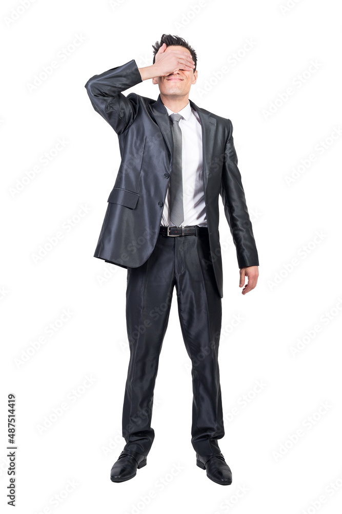 Businessman covering eyes in studio. White background. Businessman covering eyes in studio. White background.