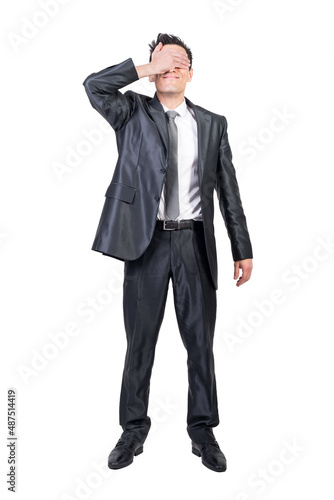 Businessman covering eyes in studio. White background.