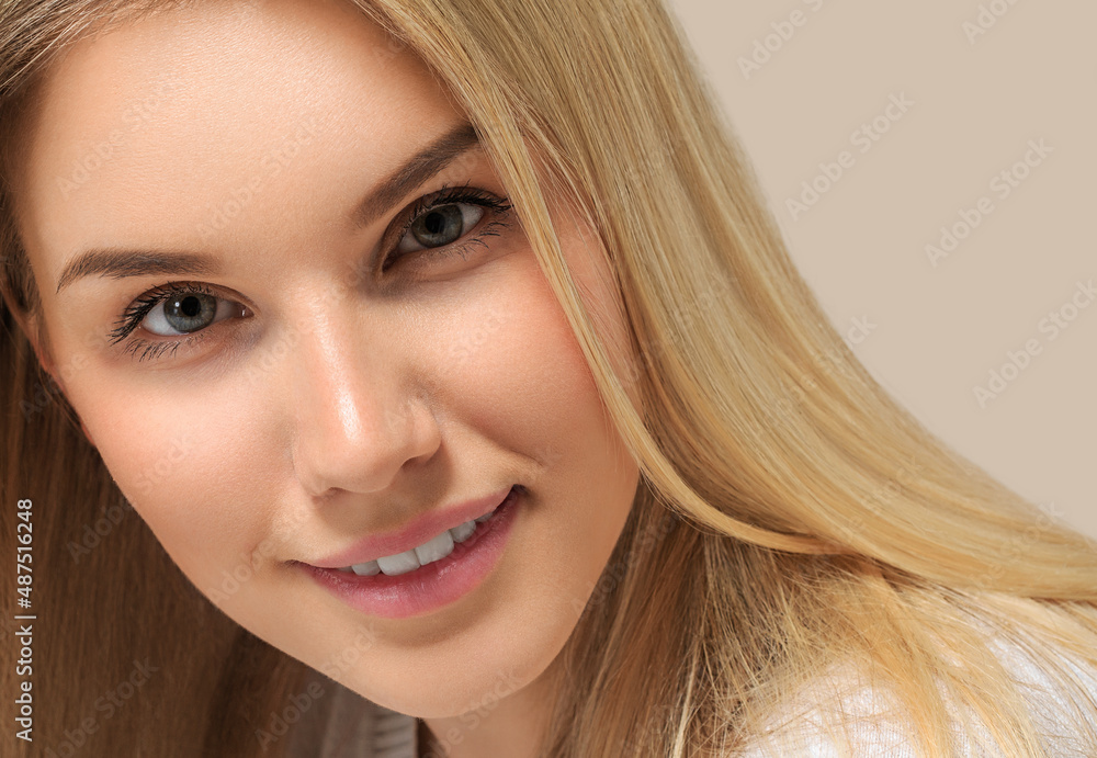 Long smooth blonde hairstyle beauty woman close up portrait. Color background brown Long smooth blonde hairstyle beauty woman close up portrait. Color background brown