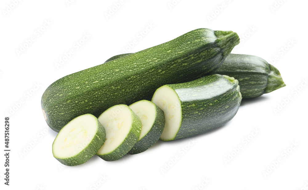 Whole and cut green ripe zucchinis isolated on white Whole and cut green ripe zucchinis isolated on white