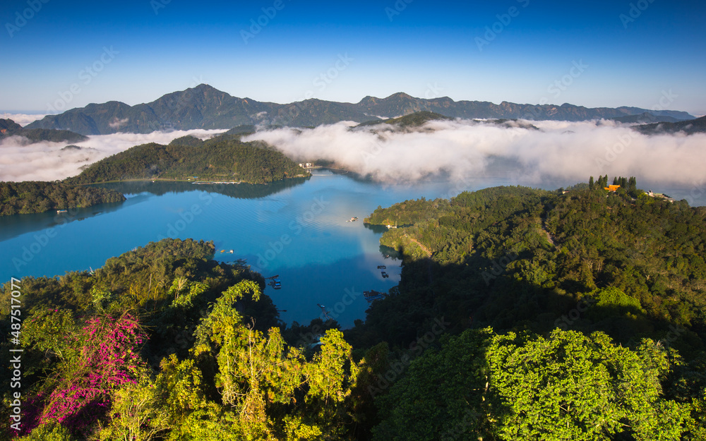Fototapeta premium Asia culture - Beautiful landscape of lake level reflect fantasy dramatic sunrise sky in Sun Moon Lake , in Taiwan, Asia. the famous travel attractions in Nantou ,Taiwan. Scenery of Sun Moon Lake,