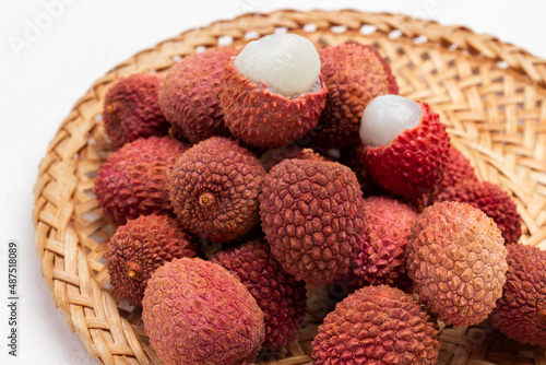 Lychee fruit on wicker plate. Close up.