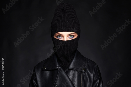 Fashionable girl in black balaclava and leather coat photo
