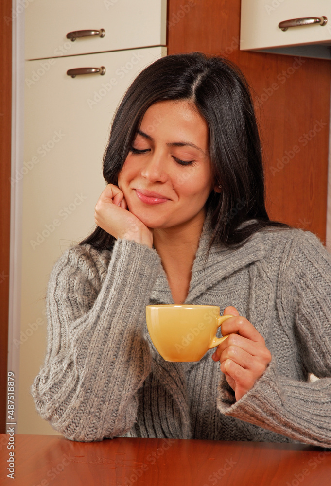 Young latin woman drinking coffe in the kitchen, Young latin woman drinking coffe in the kitchen,