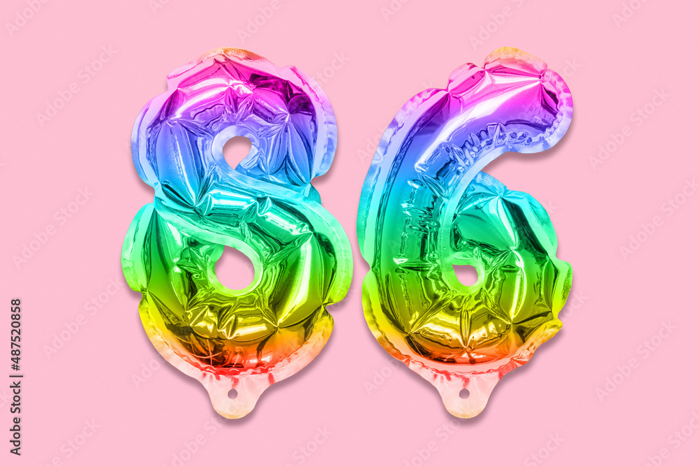 Rainbow foil balloon number, digit eighty six on a pink background. Birthday greeting card with inscription 86. Top view. Numerical digit. Celebration event, template. Rainbow foil balloon number, digit eighty six on a pink background. Birthday greeting card with inscription 86. Top view. Numerical digit. Celebration event, template.