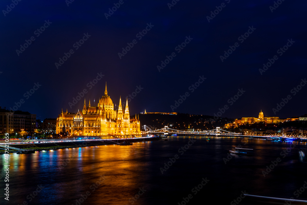 Wonderful mesmerizing view of the city at night illuminated by lights on the danube river. Wonderful architecture at night. Beautiful landscape on the parliament on the river. Hungary, budapest