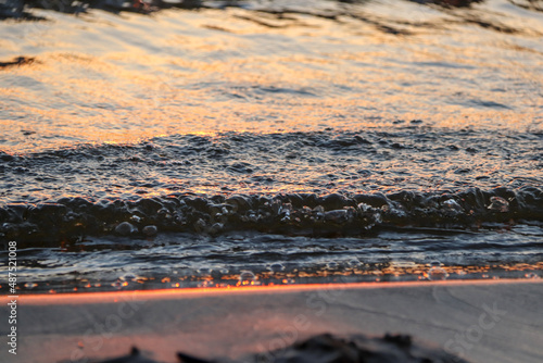 orange sunset over the bay with small wave