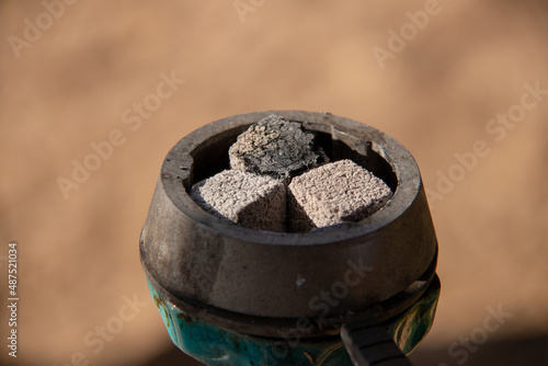 Coals for hookah close-up. Burning coals on the hookah bowl.
