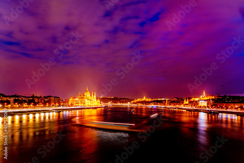 Wonderful architecture at night. Wonderful mesmerizing view of the city at night illuminated by lights on the danube river. Hungary, budapest. Beautiful landscape on the parliament on the river © watman