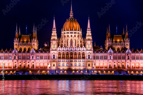 Close up. Hungarian parliament building at night, budapest, hungary. Beautiful architecture illuminated by lanterns. A beautiful old building on the danube river. A magical view of the ancient city. © watman