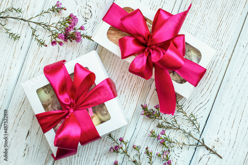 gift with a bow on a white wooden background