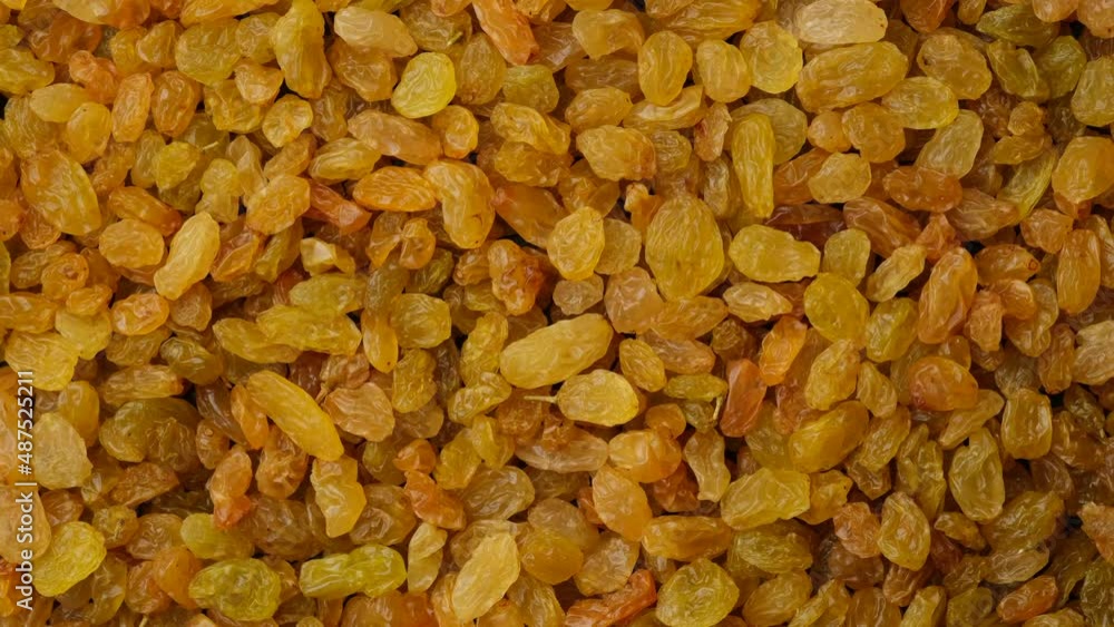 Golden sun dried raisin top view. Sliding shot. Organic food Golden sun dried raisin top view. Sliding shot. Organic food