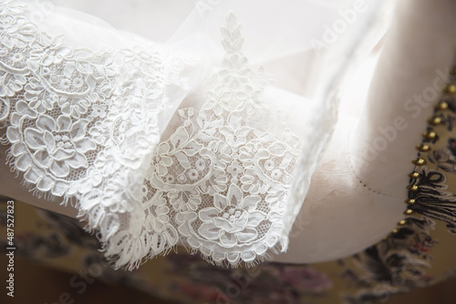 lace hem white wedding dress on background of the floor
