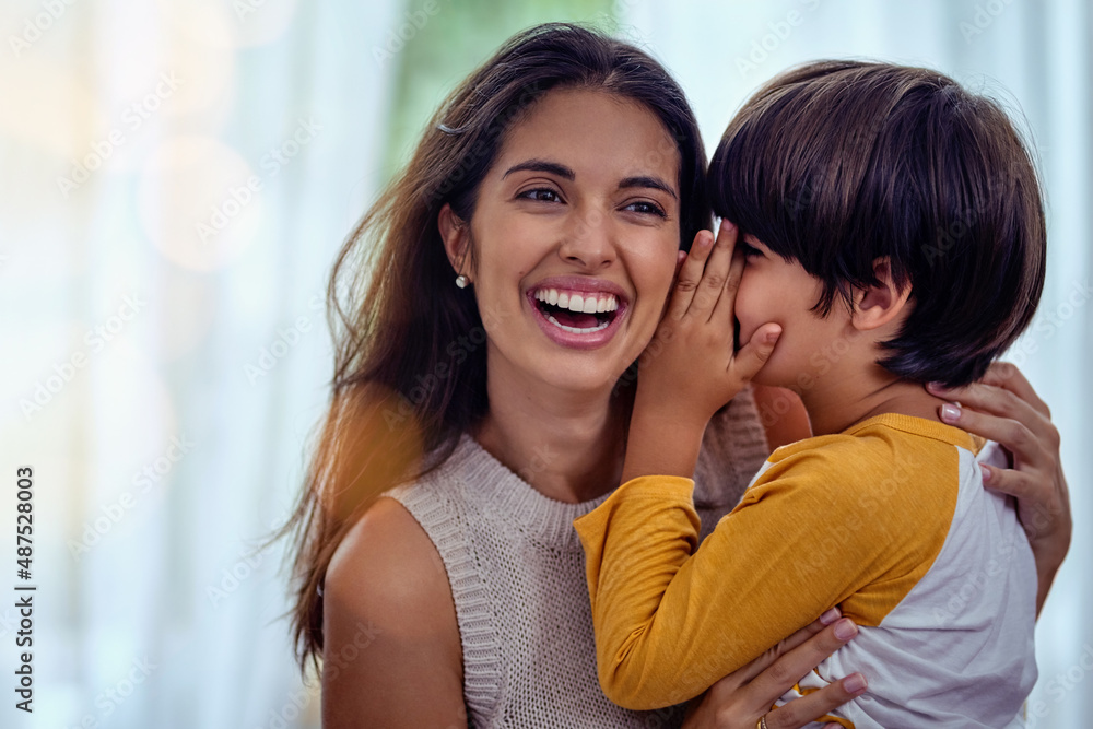 The secret language only a mom and son will understand. Shot of an adorable little boy whispering into his mothers ear. The secret language only a mom and son will understand. Shot of an adorable little boy whispering into his mothers ear.