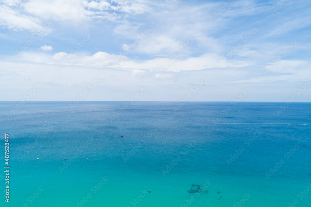 Aerial view of blue sea surface water texture background Drone flying over sea Waves water surface texture on sunny tropical ocean in Phuket island Thailand