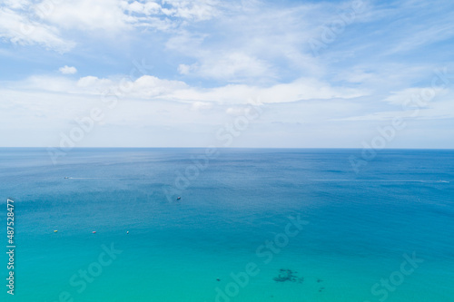 Aerial view of blue sea surface water texture background Drone flying over sea Waves water surface texture on sunny tropical ocean in Phuket island Thailand