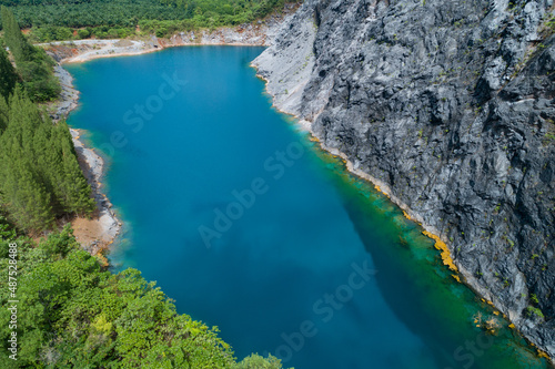 Fototapeta Naklejka Na Ścianę i Meble -  Aerial view of amazing pond in tropical rainforest forest with mountain rocks peak Beautiful water surface in Phang Nga Thailand