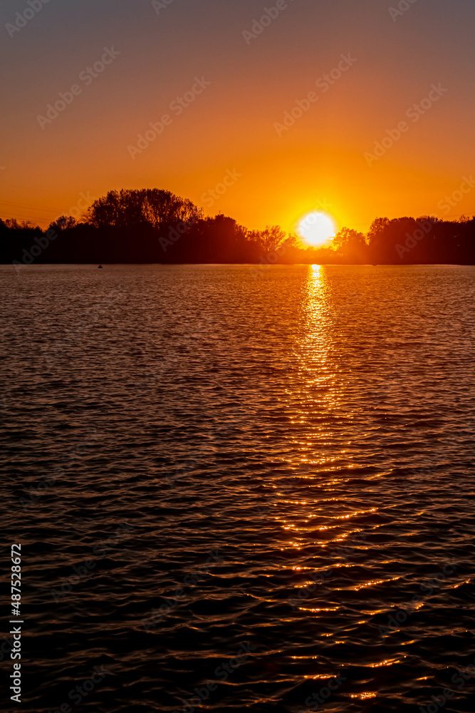 Naklejka premium Beautiful sunset with reflections at Plattling, Isar, Bavaria, Germany