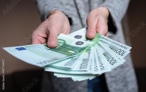 Woman counts money. female hands hold cash banknotes denominations of 100 euro currency. business man rich female hands hold and count, pay cash banknotes euros or paper banknotes