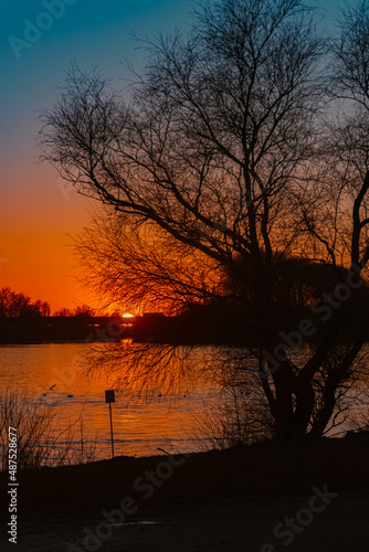 Fototapeta Naklejka Na Ścianę i Meble -  Beautiful sunset with reflections at Metten, Danube, Bavaria, Germany