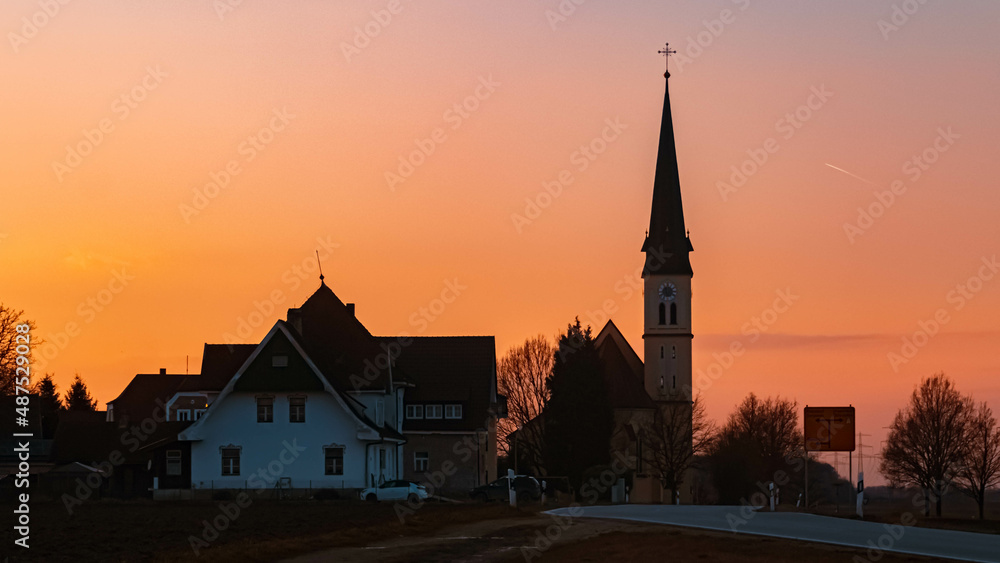 Fototapeta premium Beautiful sunset with a church silhouette near Wallerdorf, Bavaria, Germany