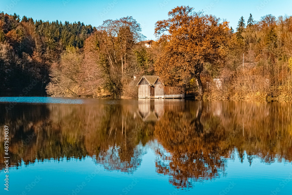 Beautiful indian summer view with reflections at the famous Hoeglwoerther See lake, Bavaria, Germany