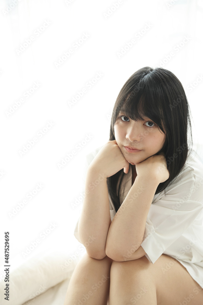 Beautiful young woman waking up in the morning at white bedroom Beautiful young woman waking up in the morning at white bedroom