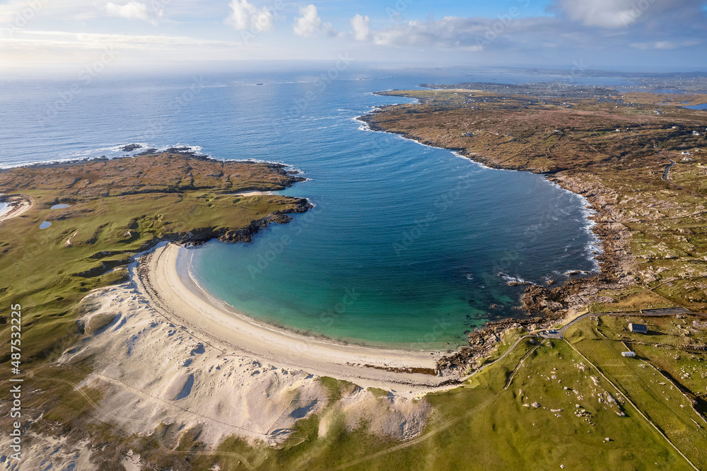 Aerial view on amazing Dog's bay beach near Roundstone town in county Galway, Sandy dunes and beach and blue turquoise color water. Cloudy sky. Popular travel destination. Gem of Connemara