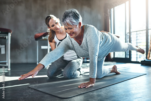 Working together to improve muscle strength and tone. Shot of a senior woman working out with her physiotherapist.