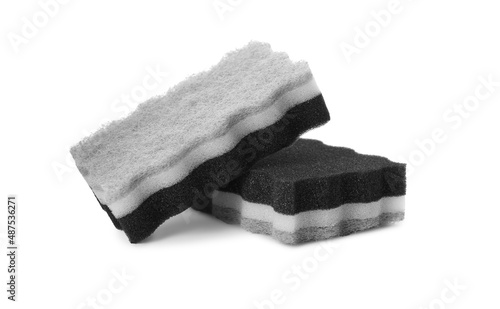 Layered cleaning sponges with abrasive scourers on white background