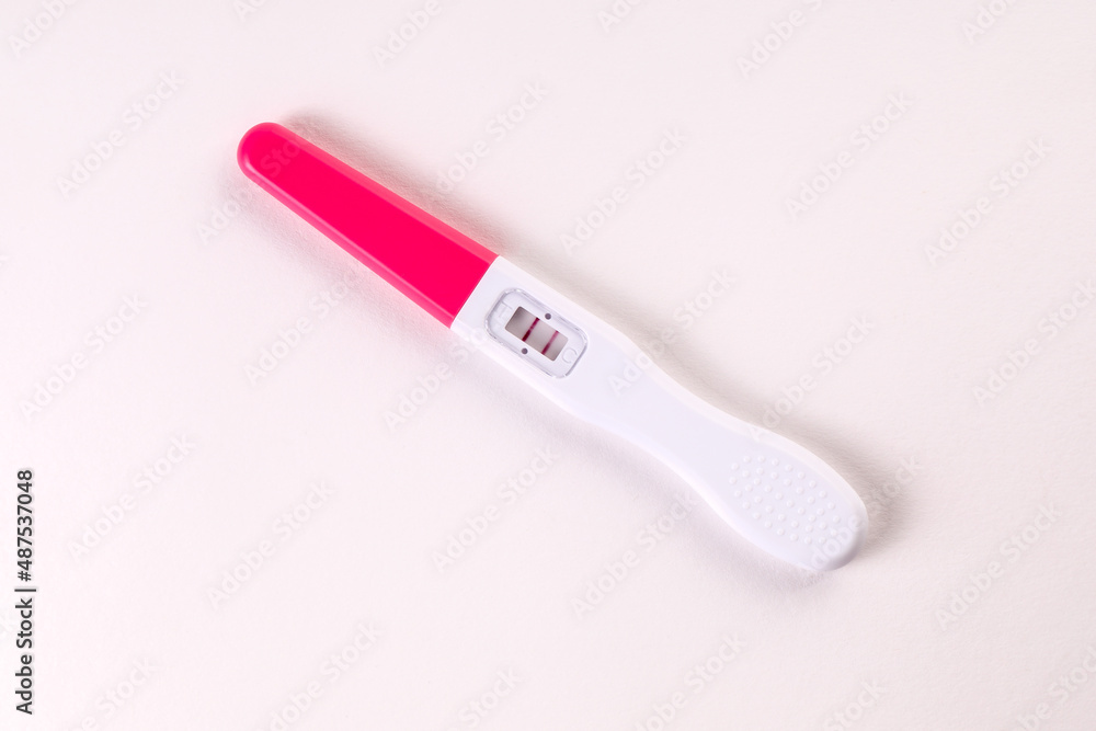 Positive pregnancy test on a white background Positive pregnancy test on a white background