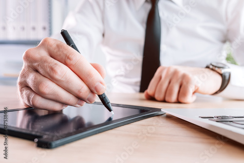 Electronic signature, businessman providing e-signature for document agreement using stylus and pad