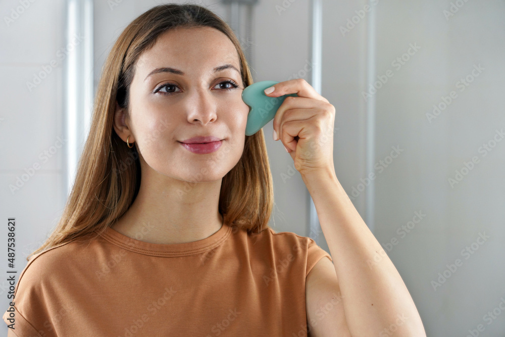 Gua Sha Jade Face Sculpting Massage. Lifting, Skincare and Lymphatic Drainage of the Skin Concept. Gua Sha Jade Face Sculpting Massage. Lifting, Skincare and Lymphatic Drainage of the Skin Concept.