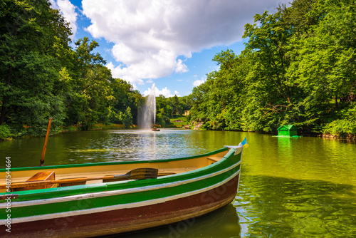 Wooden row boat standing on the pond waiting for the passengers photo