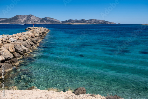 Fototapeta Naklejka Na Ścianę i Meble -  Stone breakwater with a small beacon. Koufonisia Cyclades island, Greece