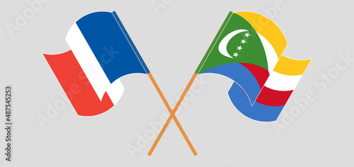 Crossed and waving flags of France and Comoros