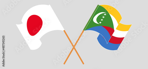 Crossed and waving flags of Japan and Comoros