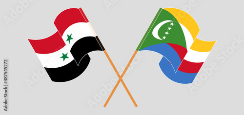 Crossed and waving flags of Syria and Comoros