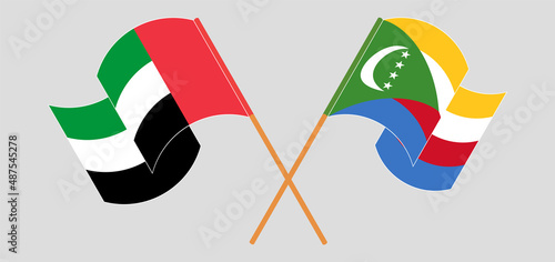 Crossed and waving flags of the United Arab Emirates and Comoros